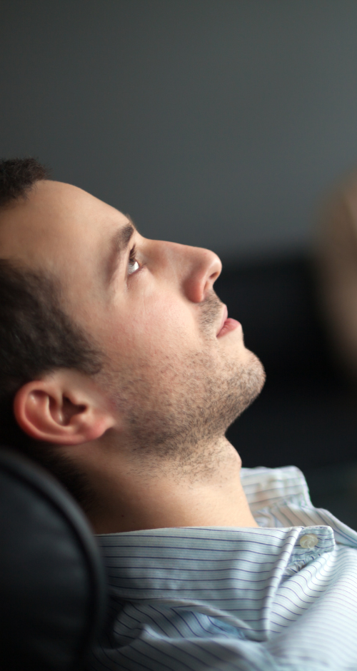 a person sitting in a chair with their eyes closed